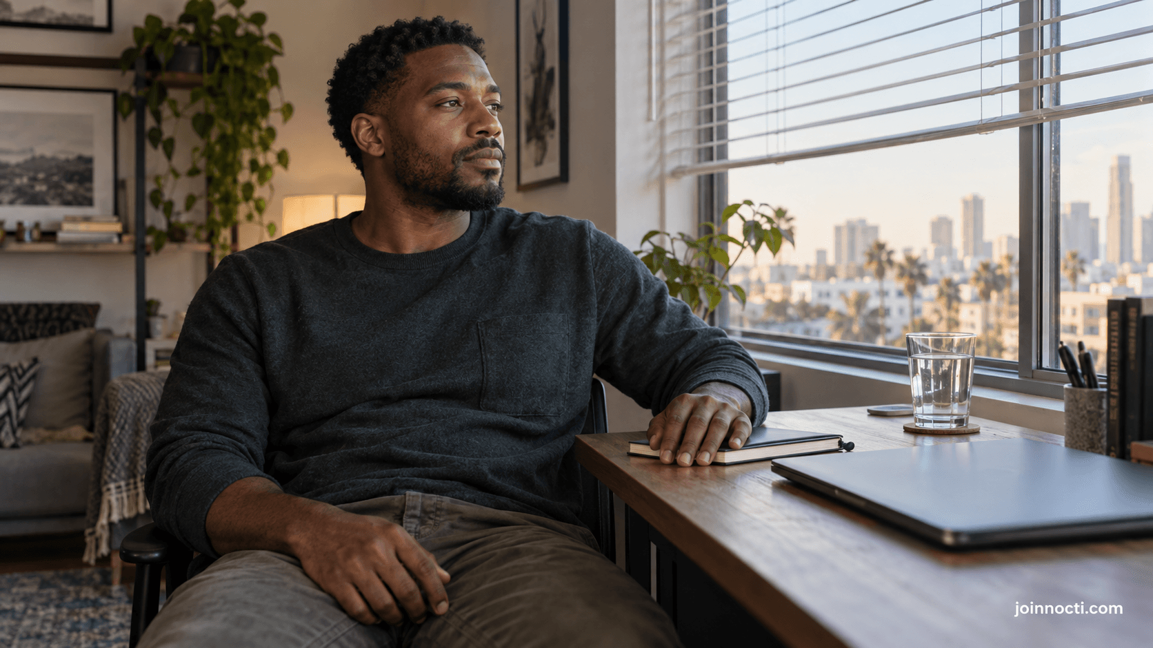 Young man pausing after work in a Southern California home office before a private health conversation