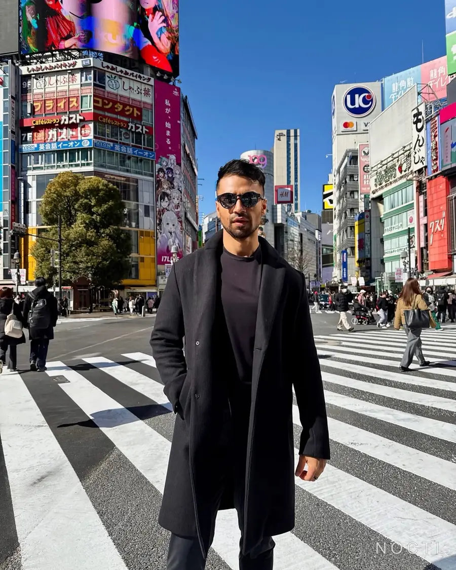 Adult male traveler at Shibuya Crossing in Tokyo beneath a subtle NOCTI mark, used as an editorial image about choosing the right service fit