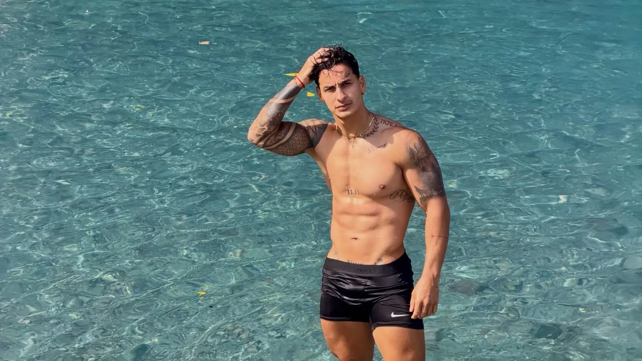 Adult male editorial model standing in clear water, illustrating men’s wellness as a regular routine